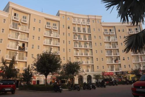 a large building with motorcycles parked in front of it at Hotel Shyam Basera in Mathura