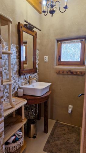 a bathroom with a sink and a mirror at Holiday House Clavis in Dobrovnik