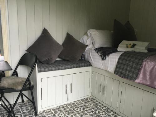 a bed with pillows sitting on top of it at York House Durham in Durham