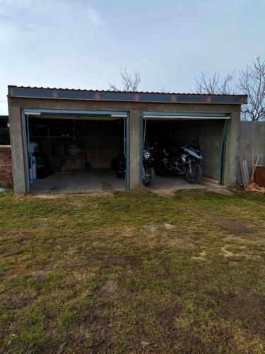 a garage with a motorcycle parked inside of it at Chata 2 in Nový Přerov