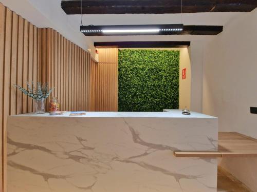 a green wall in a room with a marble counter at HOSTAL HS CEHEGIN in Cehegín