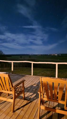 two wooden benches sitting on a wooden deck at Holiday House Clavis in Dobrovnik