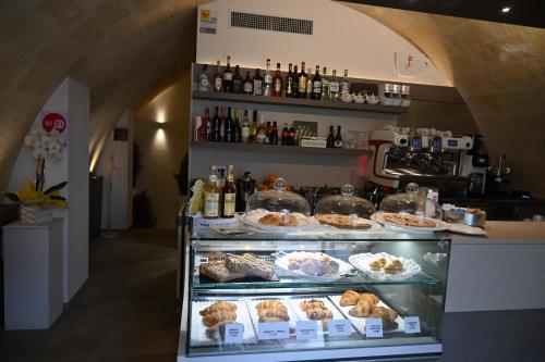 a bakery with a display case filled with pastries at Profumi di Primavera Luxury Rooms & Suite in Matera