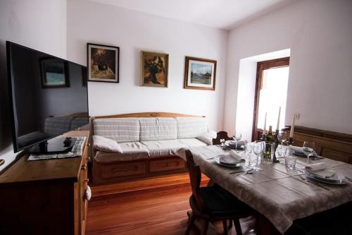a living room with a table and a bed at Reddish Deer House ::: Cadore Dolomiti in Valle di Cadore