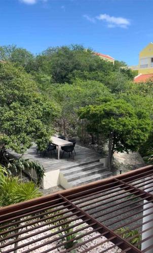 a patio with a table and chairs and trees at NewVilla-Coral Estate-WalktoBeach-Private Pool-up to 16 Guests SeaView in Willibrordus