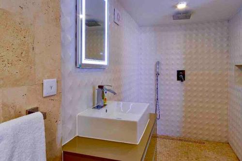 a bathroom with a white sink and a shower at NewVilla-Coral Estate-WalktoBeach-Private Pool-up to 16 Guests SeaView in Willibrordus