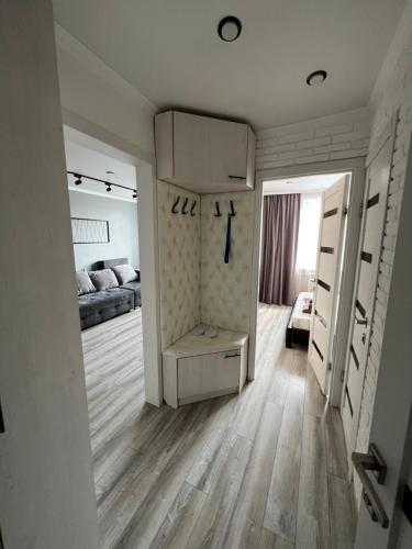 a room with a bedroom with a bed and a closet at Apartment lux Tolstogo 90. Апартаменты люкс Толстого 90 in Pavlodar