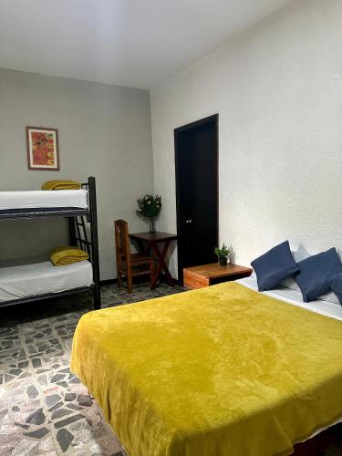 um quarto com uma cama e um beliche em Hostel Xitla em Oaxaca de Juárez