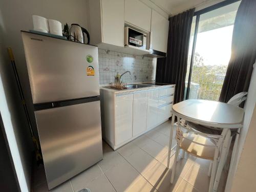 a kitchen with a stainless steel refrigerator and a sink at 1 bedroom Centrio Condominium Phuket Near Central Festival in Phuket town in Phuket