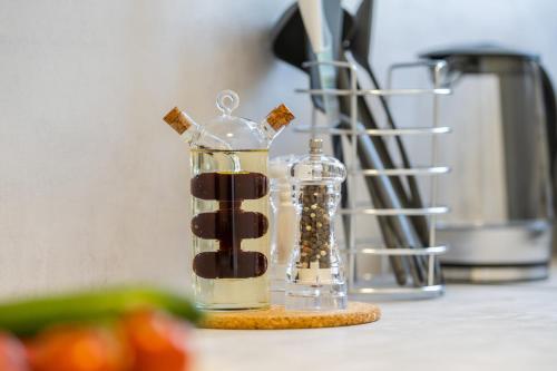 a glass container filled with chocolate on top of a counter at Luxury Seaview Apartment in Juraši