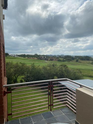 a balcony with a fence and a view of a field at 82 St Andrews Jackal Creek Golf Estate with Backup power & Golf course views in Roodepoort