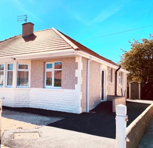 a brick house with a driveway in front of it at Eden Stay in Morecambe