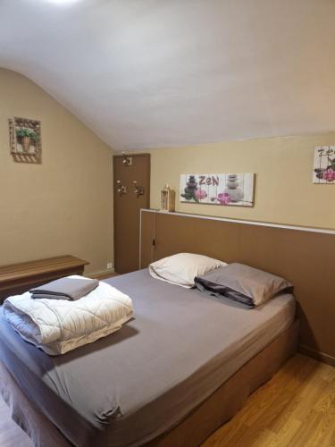 a bedroom with a bed with two pillows on it at Chalet toutou 12/14 personnes in Barèges