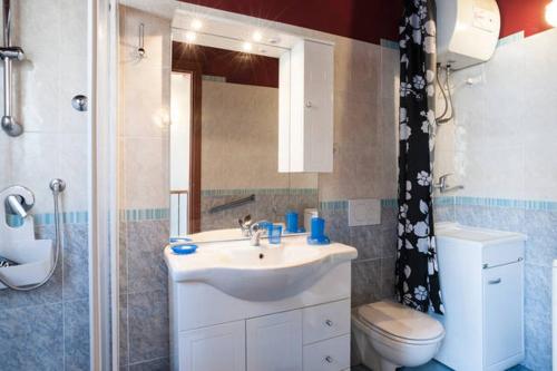 a bathroom with a sink and a toilet and a shower at Click Center Apartment in Catania
