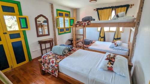 a room with two bunk beds and a door at Charming Coffee Farm House in Salento