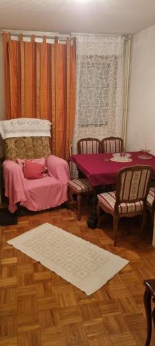 a room with a table and two chairs and a table and a table at Apartman Kosa in Bežanija