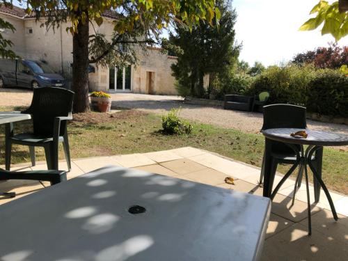 a table and chairs sitting on a patio at Hotel Karina in Jarnac