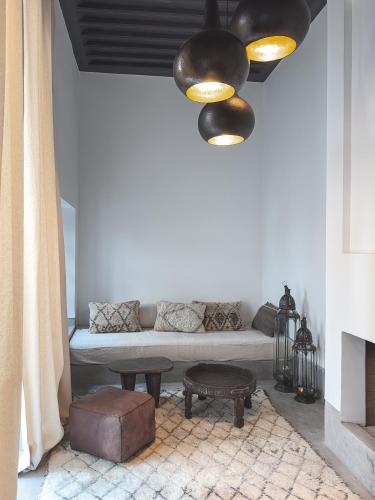 a living room with a couch and a chandelier at Riad Atay in Marrakech