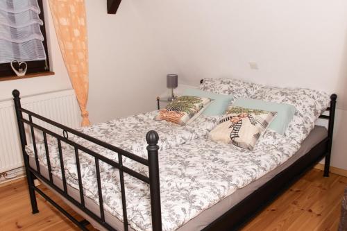 a bed with pillows on it in a room at Fachwerk Ferienhaus Elz in Elz
