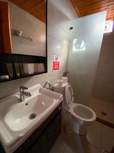 a bathroom with a sink and a toilet and a mirror at Rum Elegant luxury camp in Wadi Rum