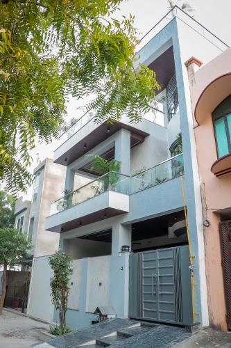 an apartment building with a garage in front of it at Anirudh Homestay in Agra