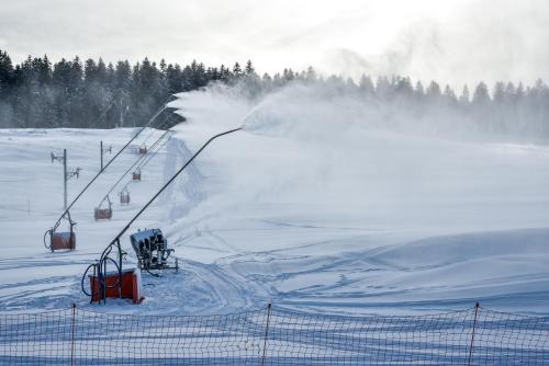 a ski slope with a ski lift in the snow at Boutique Hôtel - Notre Chalet in Les Fourgs