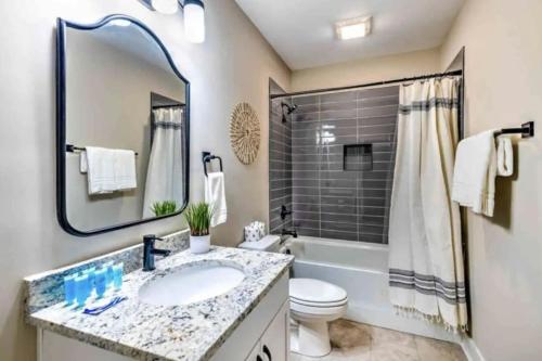 a bathroom with a sink and a tub and a toilet at Luxury four-story Home, Rooftop Deck with views, PingPong! Sleeps 12! in Nashville
