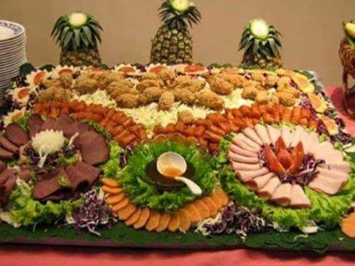 a large cake with many different types of food on it at ASSOUKA Eco-Village du lac Nokoué in Abomey-Calavi