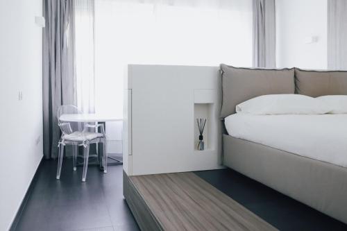 a bedroom with a bed and a table and a chair at Ugo's Urban Home: Porta Nuova District in Milan