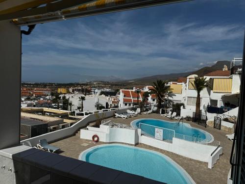 a view from the balcony of a hotel with a swimming pool at Sotavento 28 in Los Cristianos