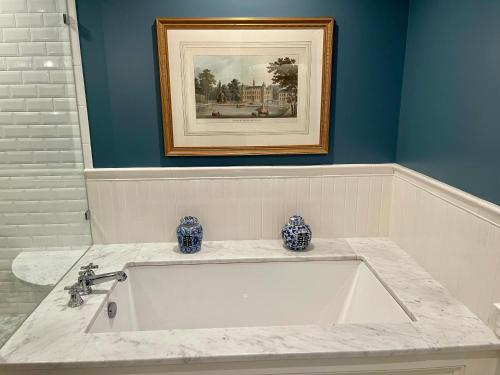 a bath tub with two vases on top of it at Hannum House in Skaneateles