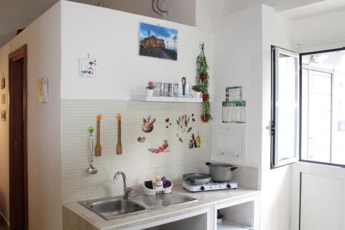 a kitchen with a sink and a counter top at Casa Milù Napoli centro in Naples