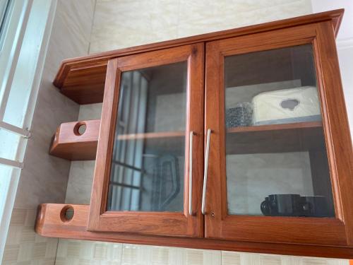 a glass cabinet with a roll of toilet paper at Luckysmallie_villa in Luisi