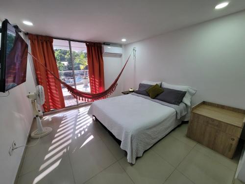 巴蘭基亞的住宿－APARTAMENTO COMPLETO 2 HABITACIONES，一间卧室设有一张床和一个大窗户