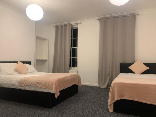 Ένα ή περισσότερα κρεβάτια σε δωμάτιο στο Warren Street Guest House