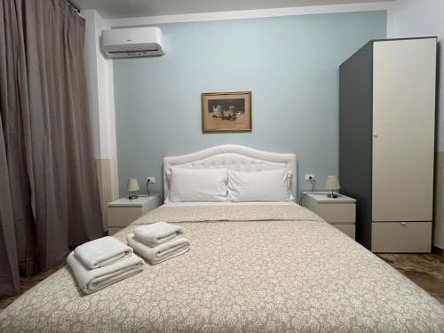 a bedroom with a bed with two towels on it at B&B Prime Sant'Agostino in Pisa