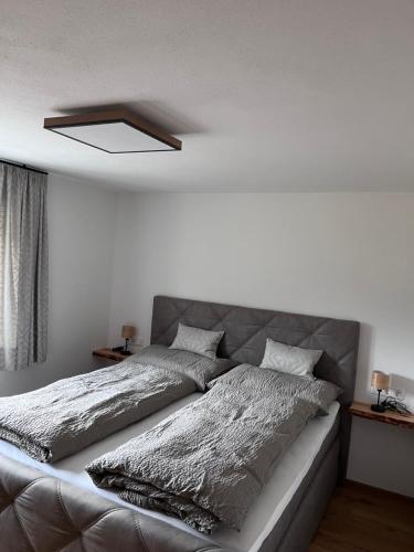 a bedroom with a silver bed with a ceiling at Apartment Tanzberger in Faistenau