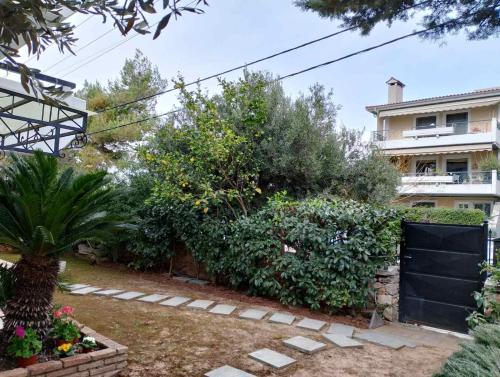 a garden with a fence and some bushes at Olive luxury two-level apartment in Athens