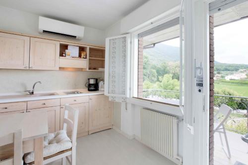 a kitchen with a table and a large window at Residence Gonda&Giuliano in Borso del Grappa