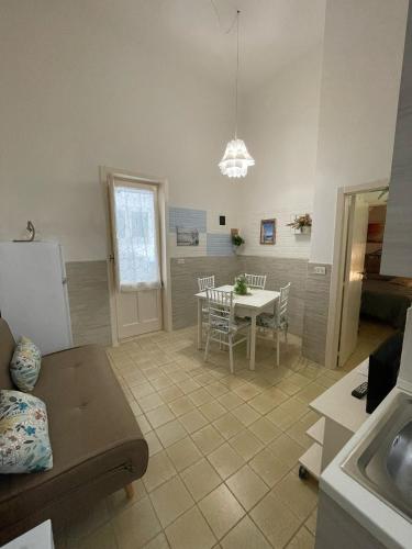 a kitchen and dining room with a table and a refrigerator at “Vistamare” in Torre rinalda