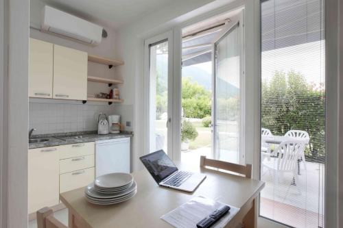 a kitchen with a table with a laptop on it at Residence Gonda&Giuliano in Borso del Grappa