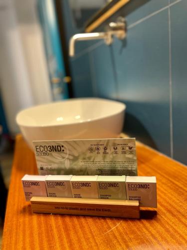 a pile of toothpaste sitting on a table next to a sink at 149 BORGO TICINO SUITE Attico di Lusso con Terrazzo e Parking Privato in Pavia