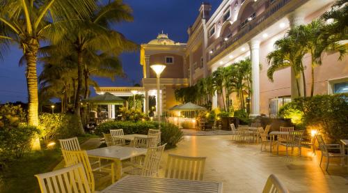 a patio with tables and chairs in front of a building at Le Beau Max Resort in Fanlu