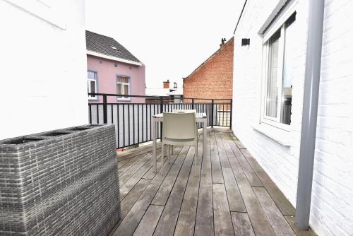 a balcony with a table and a chair on it at Cosy apartment Airport Brussels with terrace in Zaventem