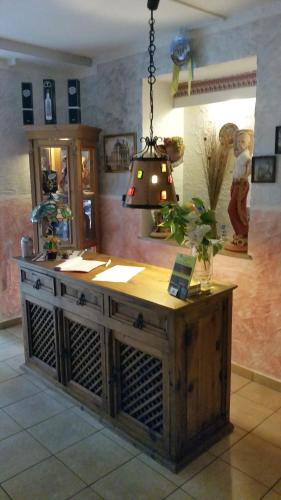 a room with a table with a lamp on it at Waldhotel Lemberg in Hagen