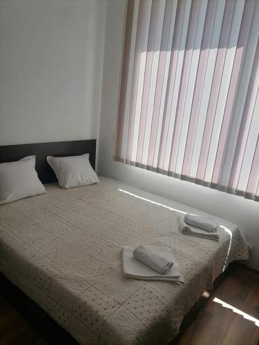 a bedroom with a bed with two towels on it at Sem.hotel -Afrikana in Sveti Vlas