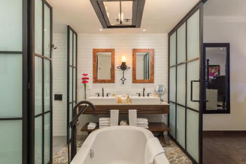 a bathroom with a tub and a sink at VISTA ENCANTADA AT HACIENDA ENCANTADA & SPA RESORT- apartment in Cabo San Lucas