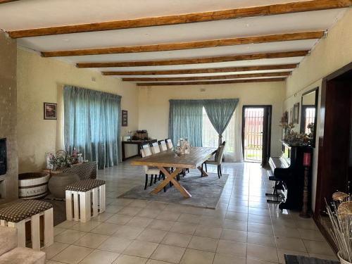 a large living room with a wooden table and chairs at Garden View Home in Brakpan