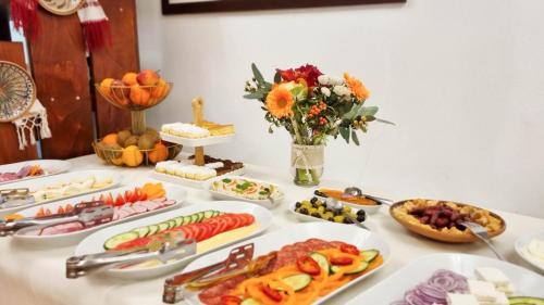a table with many plates of food on it at Dorul Pescarului in Curtea de Argeş