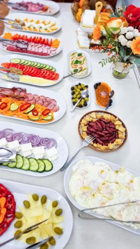 a table with many plates of food on it at Dorul Pescarului in Curtea de Argeş